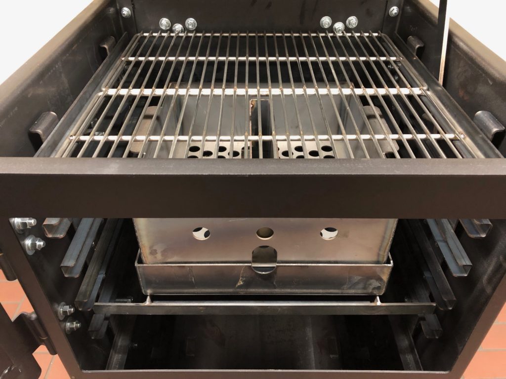 The Bar-Be-Cube firebox drawer is on rollers for easy access to the removable ash pan, charcoal and wood basket.