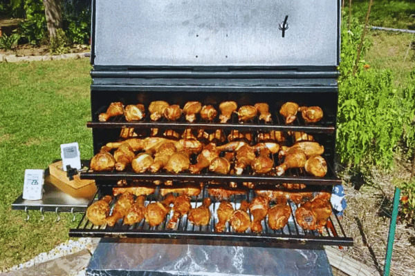 The All-Star Smoker & Grill shown smoking chicken drummies to golden brown. 