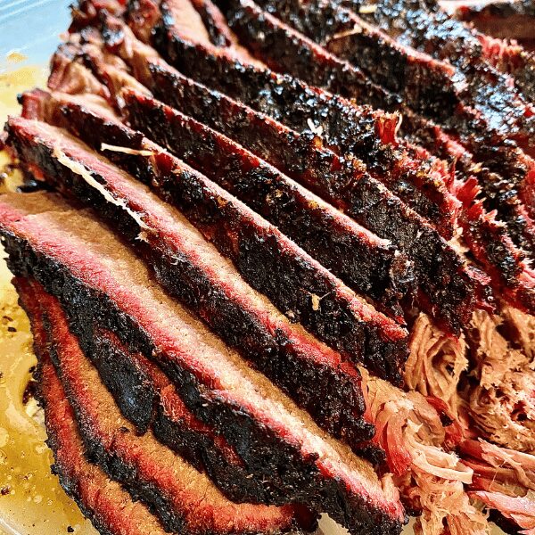 Successful brisket smoking means slicing only after resting 30 minutes to an hour to redistribute the juices.
