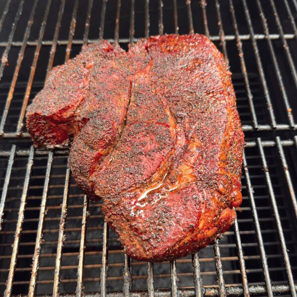 Large cut of meat with dry rub applied.